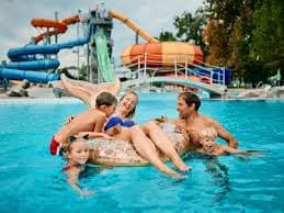 Family relaxing in a water-park pool
