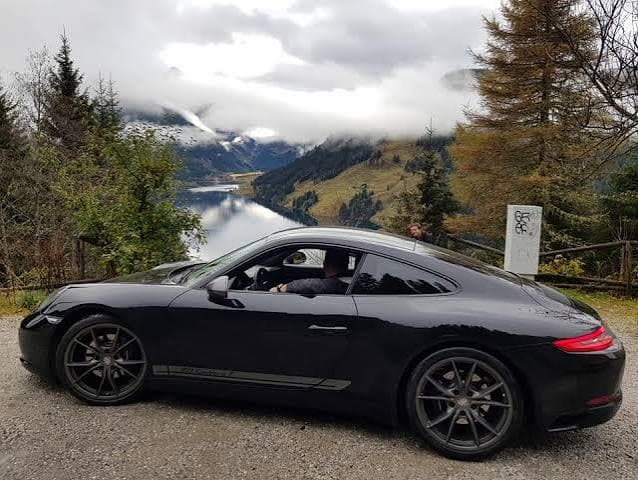 Luxury sports car at an alpine lake overlook