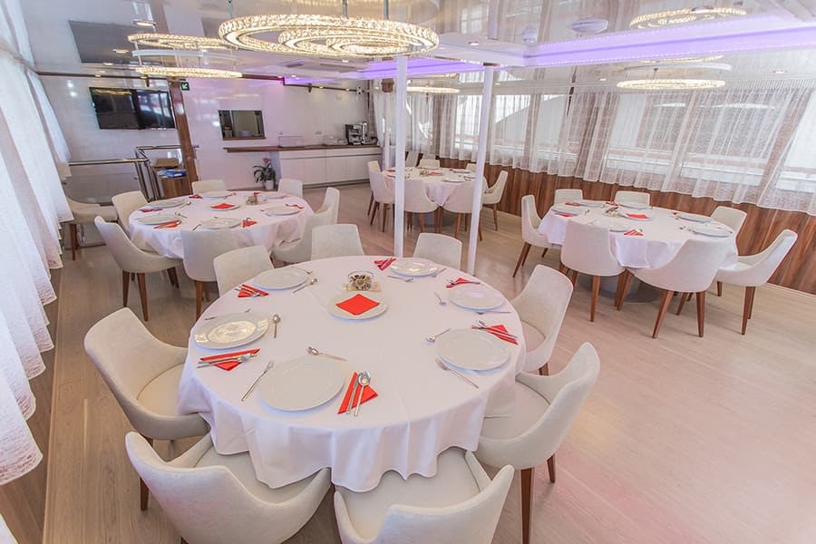 Elegant dining saloon aboard a small cruise ship
